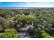 Aerial view showcasing the home amidst lush greenery, offering a glimpse of its surroundings and neighborhood at 1905 Seminole Trl, Lakeland, FL 33803
