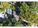 Aerial view of a home featuring a swimming pool, patio area, and lush greenery, creating a private backyard oasis at 1905 Seminole Trl, Lakeland, FL 33803