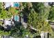 Aerial view of a home with a swimming pool, surrounded by mature trees and lush landscaping, offering privacy and beauty at 1905 Seminole Trl, Lakeland, FL 33803