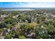 Expansive aerial view of a residential area with lush trees and a distant lake, showcasing community and natural beauty at 1905 Seminole Trl, Lakeland, FL 33803