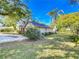 A large backyard offering a lush green lawn and mature landscaping for ultimate outdoor enjoyment at 1905 Seminole Trl, Lakeland, FL 33803