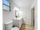 Bathroom featuring updated vanity, mirror, and toilet at 1905 Seminole Trl, Lakeland, FL 33803