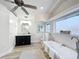 Bright bathroom with a soaking tub, modern fixtures, a vanity sink, and hardwood floors at 1905 Seminole Trl, Lakeland, FL 33803