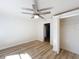 Well-lit bedroom featuring wood floors, a ceiling fan and an open closet at 1905 Seminole Trl, Lakeland, FL 33803