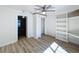 Bedroom featuring hardwood floors, a ceiling fan, built-in shelves and a closet at 1905 Seminole Trl, Lakeland, FL 33803