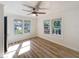 Bright bedroom featuring hardwood floors and multiple windows providing ample natural light at 1905 Seminole Trl, Lakeland, FL 33803