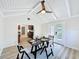 Bright dining room featuring a wood table, a ceiling fan, and access to the kitchen, perfect for Gathering gatherings at 1905 Seminole Trl, Lakeland, FL 33803