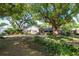 Charming home featuring a brick facade, lush landscaping, a blue front door, and a circular driveway at 1905 Seminole Trl, Lakeland, FL 33803