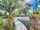 Beautifully landscaped front yard with stone pathway and mature trees creating a serene approach to the home at 1905 Seminole Trl, Lakeland, FL 33803