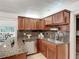 Eat-in kitchen with updated stainless dishwasher, granite countertops and wood cabinets at 1905 Seminole Trl, Lakeland, FL 33803