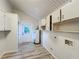 Well-lit laundry room with washer and dryer hookups and ample cabinet space at 1905 Seminole Trl, Lakeland, FL 33803