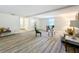 Bright living room boasts stylish seating, wood-look floors, and neutral decor at 1905 Seminole Trl, Lakeland, FL 33803