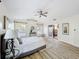 Bright main bedroom featuring windows for natural light, a ceiling fan, and hardwood floors at 1905 Seminole Trl, Lakeland, FL 33803