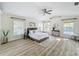 Beautiful main bedroom offering windows for natural light, a ceiling fan, and hardwood floors at 1905 Seminole Trl, Lakeland, FL 33803