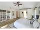 Spacious main bedroom featuring an ensuite bath, a ceiling fan, and beautiful wooden floors at 1905 Seminole Trl, Lakeland, FL 33803