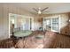 Charming brick-paved patio with ceiling fan, patio furniture, and access to interior rooms through glass doors at 1905 Seminole Trl, Lakeland, FL 33803