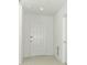 A home entryway with light tile flooring, white walls and a large exterior door at 2430 Slippery Rock St, Auburndale, FL 33823