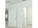 Bright hallway with white doors leading to other rooms in the house at 2430 Slippery Rock St, Auburndale, FL 33823