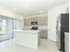 Bright kitchen featuring stainless steel appliances, modern cabinetry, and a large center island at 2430 Slippery Rock St, Auburndale, FL 33823