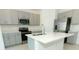 Modern kitchen featuring gray cabinetry, stainless steel appliances, and a center island at 2430 Slippery Rock St, Auburndale, FL 33823