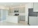 Bright kitchen featuring stainless steel appliances, modern cabinetry, and a large center island at 2430 Slippery Rock St, Auburndale, FL 33823
