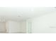 Bright, expansive living room with modern lighting and a neutral color palette at 2430 Slippery Rock St, Auburndale, FL 33823
