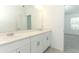 Bright bathroom features double sinks, vanity with storage, and large mirror for added convenience at 2446 Slippery Rock St, Auburndale, FL 33823