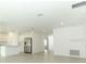 Open concept living room area with an adjoined kitchen featuring recessed lighting at 2446 Slippery Rock St, Auburndale, FL 33823