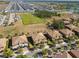 Expansive aerial shot showcasing a residential community with numerous homes, a sports field, and surrounding greenery at 8983 Azalea Sands Ln # 8983, Davenport, FL 33896