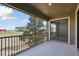 A covered balcony with black metal railings offers relaxing outdoor living with a screened enclosure and views of the green landscape at 8983 Azalea Sands Ln # 8983, Davenport, FL 33896