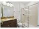 Bathroom features a glass-enclosed shower, granite-topped dark wood vanity, a framed mirror, and modern fixtures at 8983 Azalea Sands Ln # 8983, Davenport, FL 33896