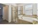 Modern bathroom featuring a soaking tub, a shower, and light-colored tile at 8983 Azalea Sands Ln # 8983, Davenport, FL 33896