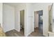 Bright bathroom with gray wood-look floors, a shower, and a separate toilet room at 8983 Azalea Sands Ln # 8983, Davenport, FL 33896