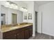 Bright bathroom with double sinks and granite countertop with modern lighting at 8983 Azalea Sands Ln # 8983, Davenport, FL 33896