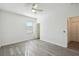 Bright bedroom features a window with blinds and luxury vinyl plank flooring offering simple, modern design at 8983 Azalea Sands Ln # 8983, Davenport, FL 33896