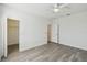 An airy bedroom with luxury vinyl plank floors features a ceiling fan and multiple closets for ample storage at 8983 Azalea Sands Ln # 8983, Davenport, FL 33896
