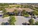 Aerial view of a clubhouse with palm trees and attractive landscaping with ample parking and a grand entrance at 8983 Azalea Sands Ln # 8983, Davenport, FL 33896