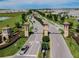 Scenic aerial view of Champions Gate entrance with decorative pillars, landscaped greenery, and smooth roadways at 8983 Azalea Sands Ln # 8983, Davenport, FL 33896