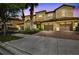 Townhome exterior showing covered garages, tropical landscaping, and multi-tone facade at 8983 Azalea Sands Ln # 8983, Davenport, FL 33896