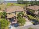 Beautiful aerial view of a luxurious home with a tile roof, three-car garage, and manicured landscaping at 8983 Azalea Sands Ln # 8983, Davenport, FL 33896