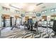 Well-equipped fitness center with modern machines, natural light, and a spacious layout for a complete workout experience at 8983 Azalea Sands Ln # 8983, Davenport, FL 33896