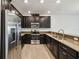 The kitchen features stainless steel appliances and dark cabinets with ample counter space at 8983 Azalea Sands Ln # 8983, Davenport, FL 33896