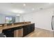 Features a modern kitchen with stainless steel dishwasher and granite countertops overlooking living area at 8983 Azalea Sands Ln # 8983, Davenport, FL 33896