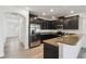 Kitchen featuring dark wood cabinetry, stainless steel appliances, and breakfast bar at 8983 Azalea Sands Ln # 8983, Davenport, FL 33896