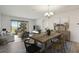 Bright living room with contemporary furniture, dining table, and sliding glass doors to the balcony at 8983 Azalea Sands Ln # 8983, Davenport, FL 33896