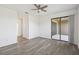 Bright living area with a sliding door to a patio and wood-look floors at 8983 Azalea Sands Ln # 8983, Davenport, FL 33896