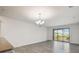Open concept living area with chandelier and sliding doors to balcony overlooking a field at 8983 Azalea Sands Ln # 8983, Davenport, FL 33896