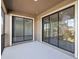 A covered patio with sliding glass doors offers views of the surrounding landscape at 8983 Azalea Sands Ln # 8983, Davenport, FL 33896