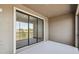 A covered patio with a sliding glass door offers views of the surrounding landscape at 8983 Azalea Sands Ln # 8983, Davenport, FL 33896