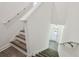 Clean, bright stairway features wood and white trim, with view of the front door at 8983 Azalea Sands Ln # 8983, Davenport, FL 33896